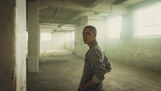 Portrait of young man in empty warehouse