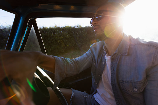 Young man on a road trip driving a pick-up truck