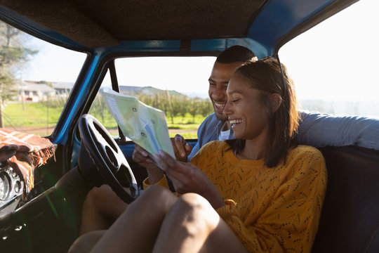 Young couple on a road trip in their pick-up truck