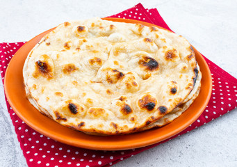Indian Cuisine - Tandoori Roti whole wheat flat bread made from stoneground wholemeal flour, Traditionally known as atta, and water that is combined into a dough