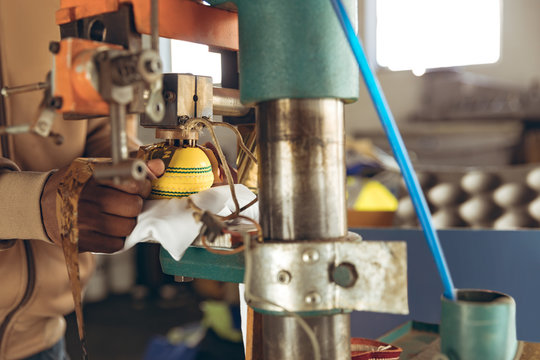 Young man working in a sports equipment factory