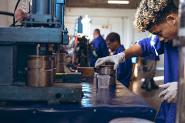 Young man working in sports equipment factory