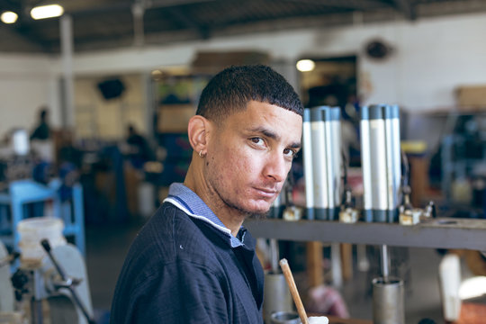 Portrait of a young man in a sports equipment factory