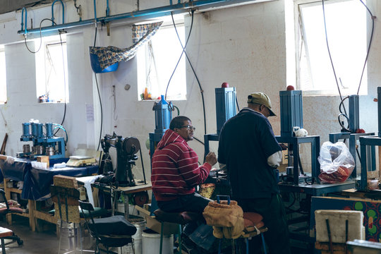 Men working in a sports equipment factory