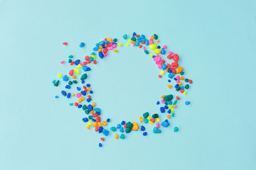 Colorfull sea stones in circle frame on blue background