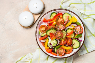 Vegetable salad on light table top view.