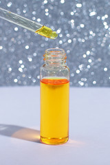 Cosmetic or medical bottle with pipette. Gold liquid product