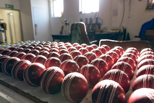 Red cricket balls in a row