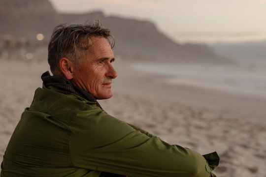 Middle aged man enjoying time outside by the sea
