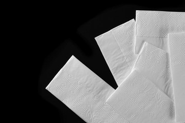 White tissues, handkerchiefs isolated on black background, top view