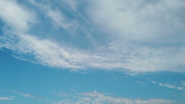 Cirrus clouds in a beautiful summer blue sky background in timelapse, good weather in time lapse