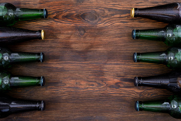 different beer bottles on wooden table . Top view