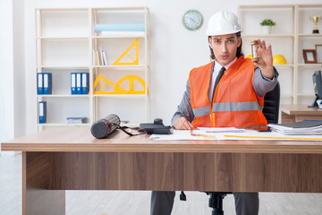 Young male architect working in the office