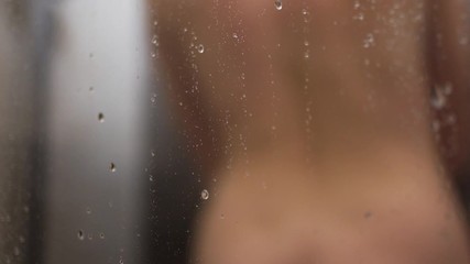 young woman taking a shower in slow motion. beautiful young girl washing and enjoy herself under a shower