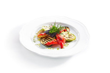 White Restaurant Plate of Grilled Vegetables and Fresh Greens Isolated