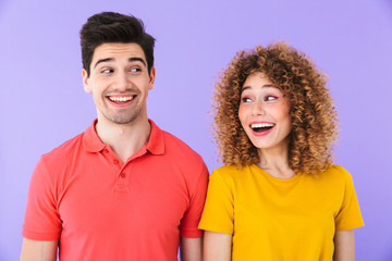 Obraz premium Portrait of pretty caucasian people man and woman in basic clothing smiling and looking at each other