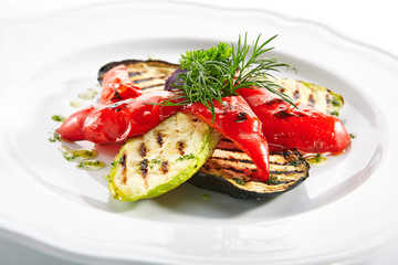 White Restaurant Plate of Grilled Vegetables and Fresh Greens Isolated