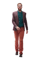 full growth. a confident young man walks forward. isolated on white