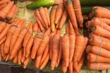 Beautiful colorful close-up shot of vegetable cucumber,cabbage and carrot displayed on a wheelbarrow in a local Africa market