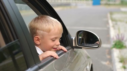 Close-up of a rude boy throws trash out the car window onto the road. Pollution of nature and the environment. Slow motion. Mom did not teach the child to throw garbage into the trash can.