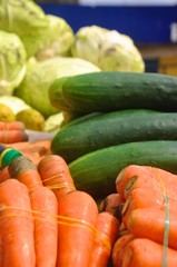 Beautiful colorful close-up shot of vegetable cucumber,cabbage and carrot displayed on a wheelbarrow in a local Africa market