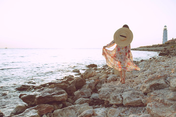 Beautiful woman on the nature. Woman by the sea at sunset.