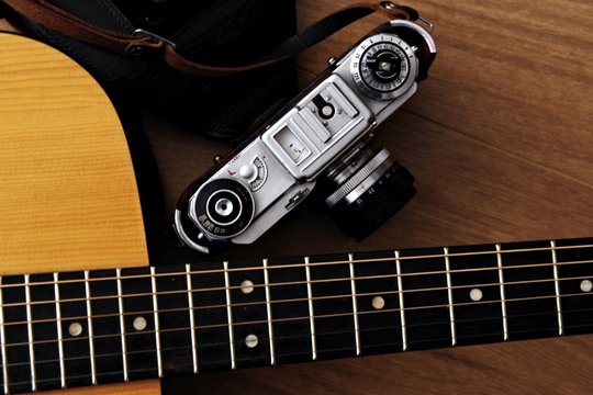 acoustic classic gutar neck with vintage film camera