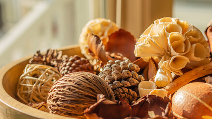 Wooden Bowl of Assorted Decorative Wood Ornaments and Pinecones