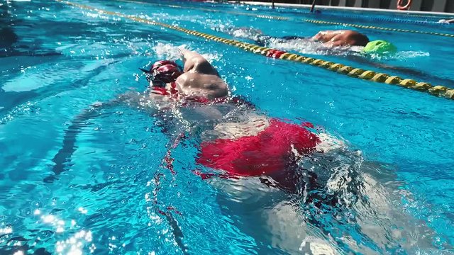 Professional swimmer in slow motion. Woman swim freestyle in pool