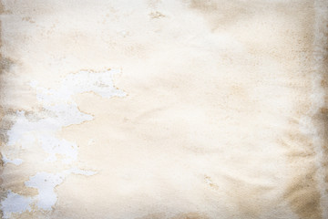 Old brown and white paper stained with coffee. Vintage abstract background.
