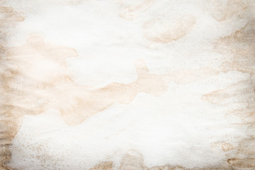 Old brown and white paper stained with coffee. Vintage abstract background.