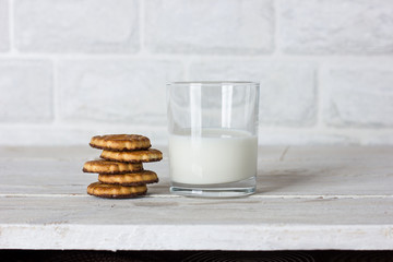 Dishes. Glass cup with milk and cookies