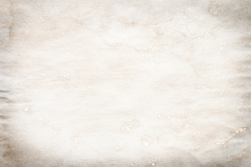 Old brown and white paper stained with coffee. Vintage abstract background.