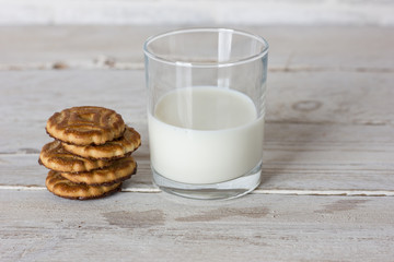Dishes. Glass cup with milk and cookies