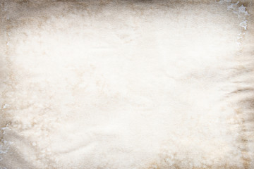 Old brown and white paper stained with coffee. Vintage abstract background.