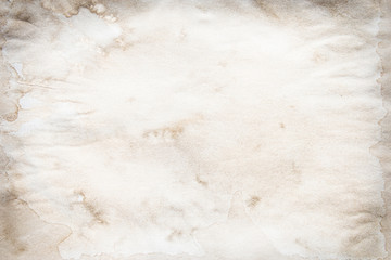 Old brown and white paper stained with coffee. Vintage abstract background.