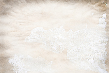 Old brown and white paper stained with coffee. Vintage abstract background.