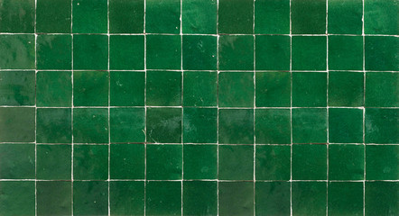 Old retro dark green ceramic tile texture background. Dark green square tiled wall.