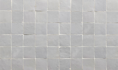 Old grey ceramic tile texture background. Grey square tiled wall.