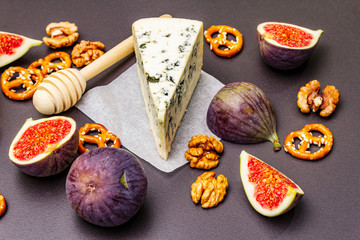 Cheese appetizer selection or wine snack set. Blue cheese, figs, honey, walnuts, pretzels