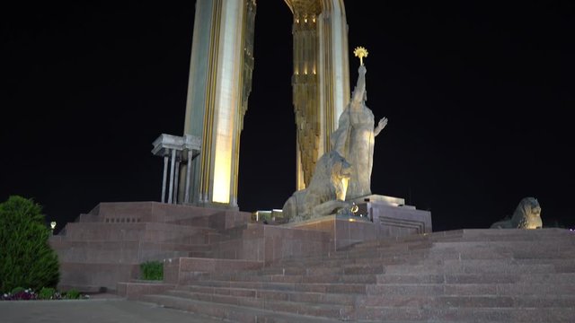 Dushanbe Ismoil Somoni Holding with his Right Hand a Scepter Statue Side View next to Rudaki Avenue at Night