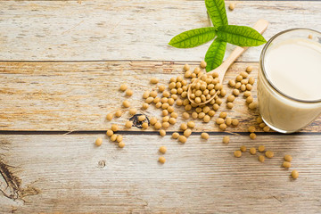 Soy milk and soy bean it on wood table background,healthy concept. Benefits of Soy.