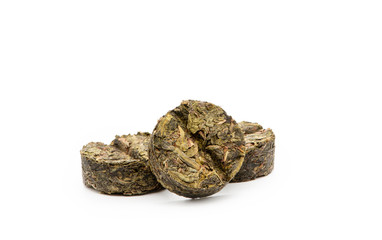 Dry compressed green tea close-up isolated on a white background, front view