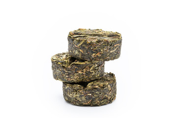 Dry compressed green tea close-up isolated on a white background, front view