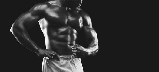 Fototapeta na wymiar Muscular arms and torso demonstrated by african american bodybuilder