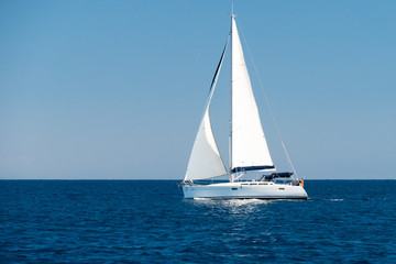 a sailingboat at sea outside the coast of Corsica - obrazy, fototapety, plakaty