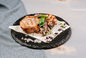 Tasty roasted steak with spices on the wooden background