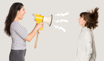 Angry mother shouting through megaphone at girl