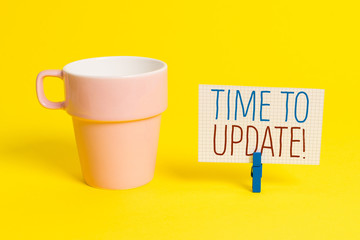 Word writing text Time To Update. Business photo showcasing act updating something someone or updated version program Cup empty paper blue clothespin rectangle shaped reminder yellow office