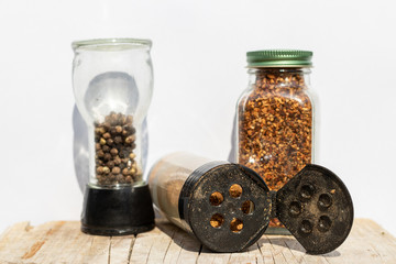 Three jars with spices of different grinding on a white backgrou